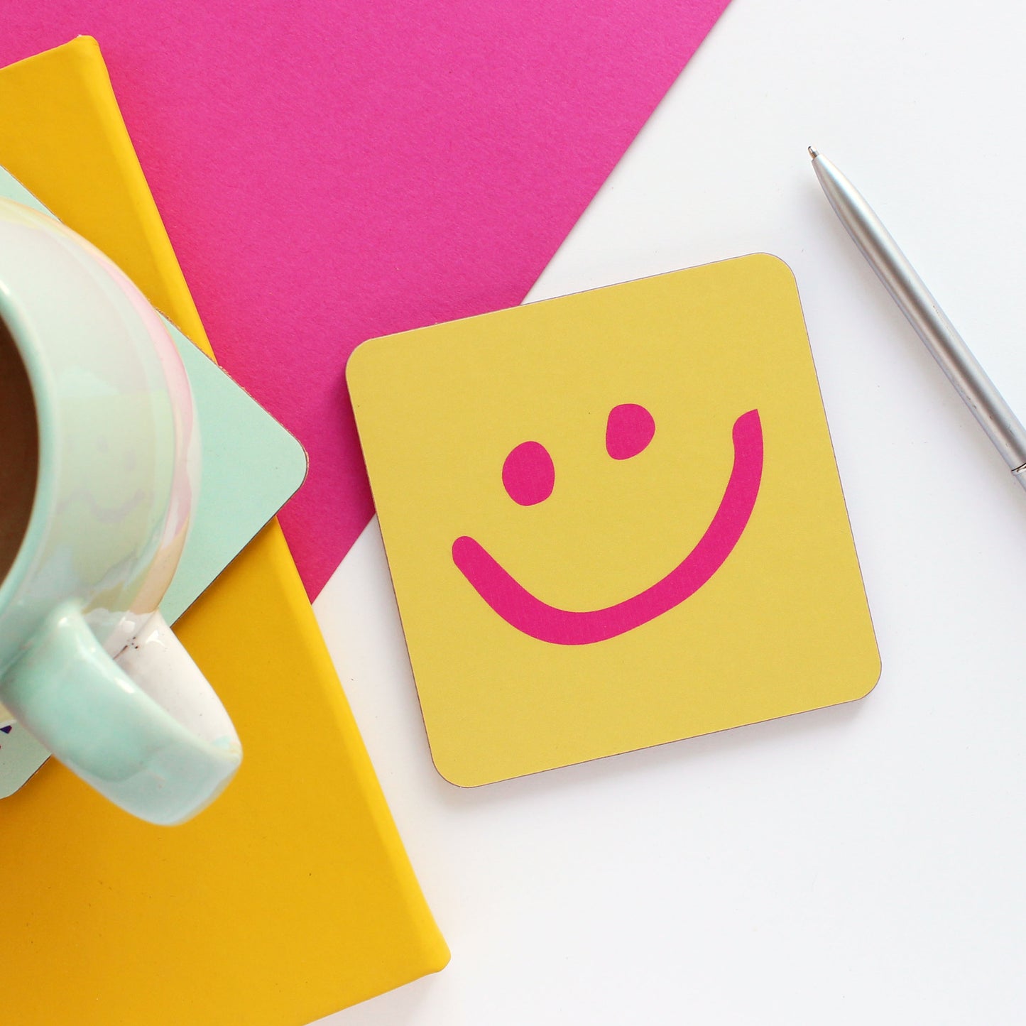 Yellow coaster with a pink happy face from Purple Tree Designs